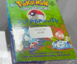 A close-up of a factory-sealed Pokémon TCG Overgrowth Theme Deck, showing the cellophane wrap.