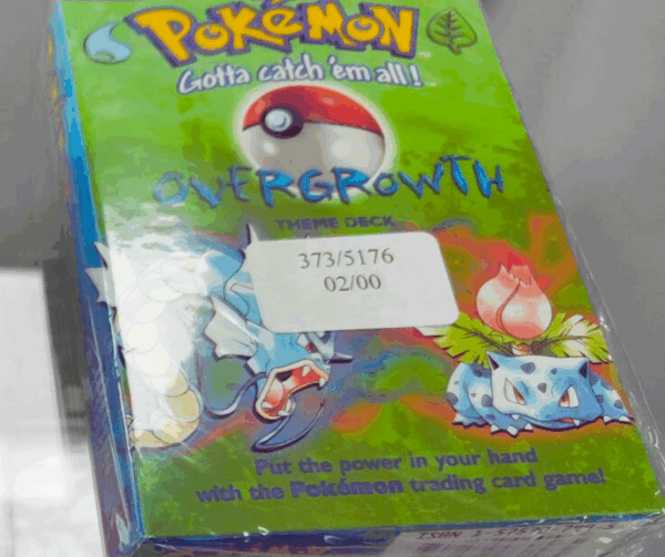 A close-up of a factory-sealed Pokémon TCG Overgrowth Theme Deck, showing the cellophane wrap.