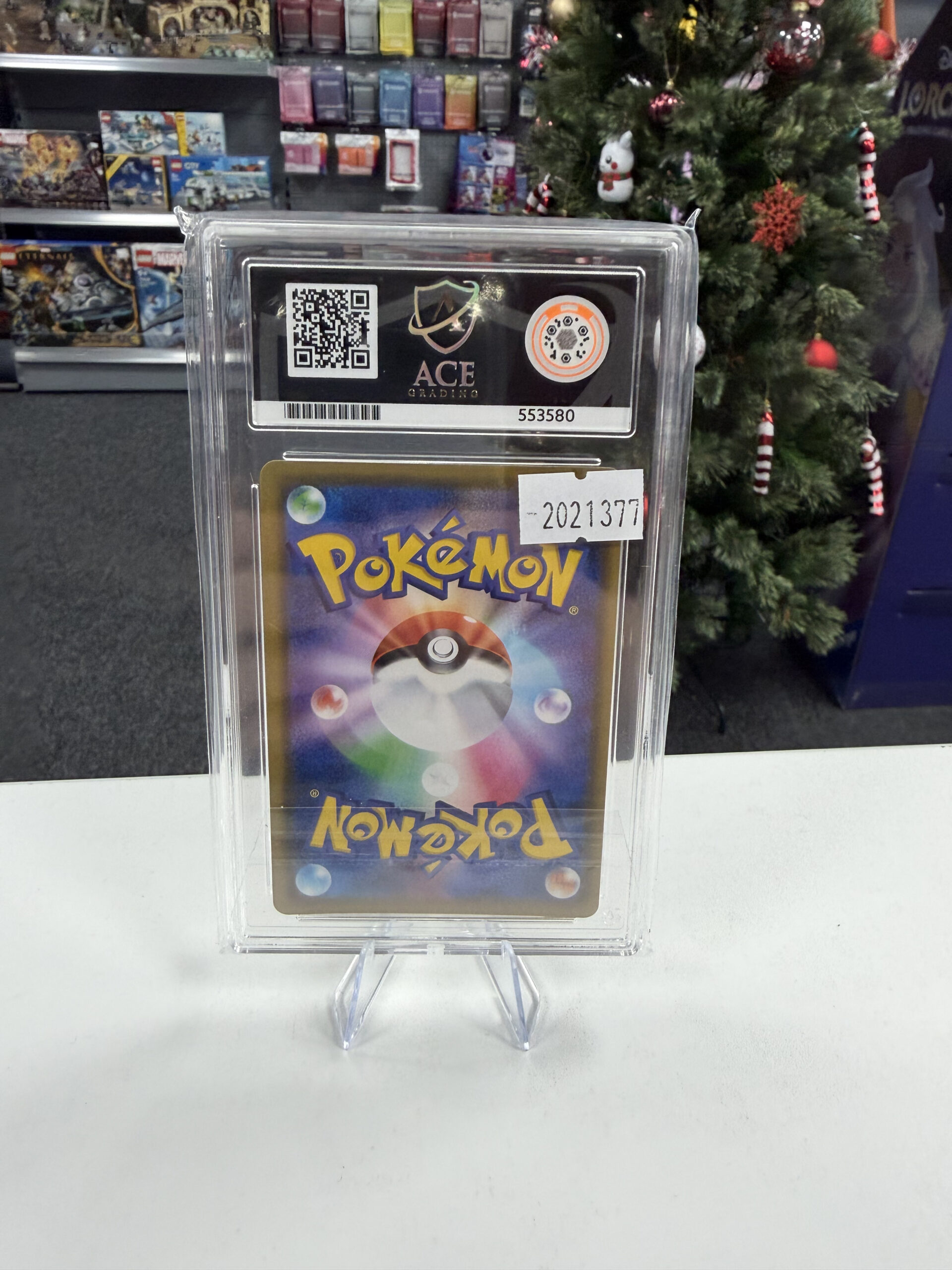 Back of ACE Grading slab showing QR code and certification number 553580 for Reshiram and Charizard GX
